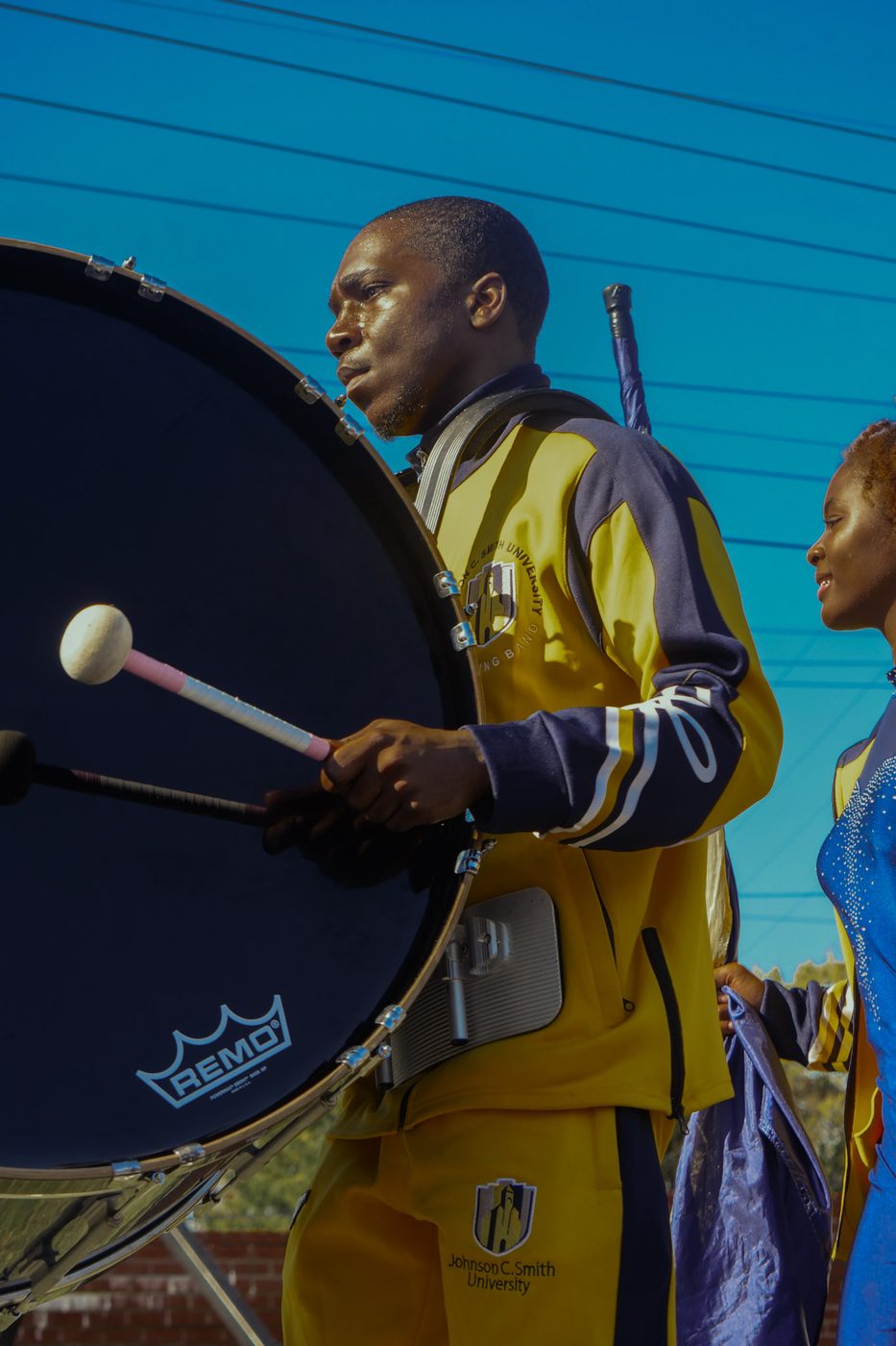 A bass drummer against an open sky