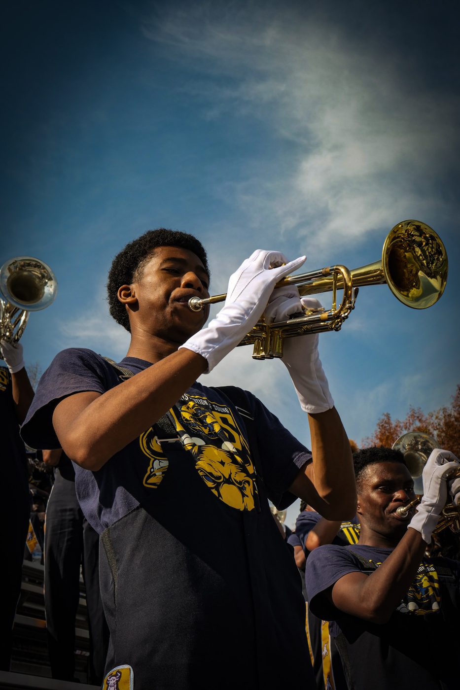 Trumpet players performing against the sky