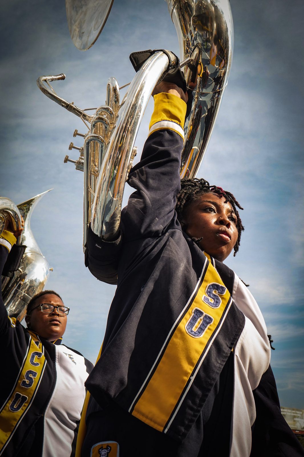 A sousaphone raised against a blue sky