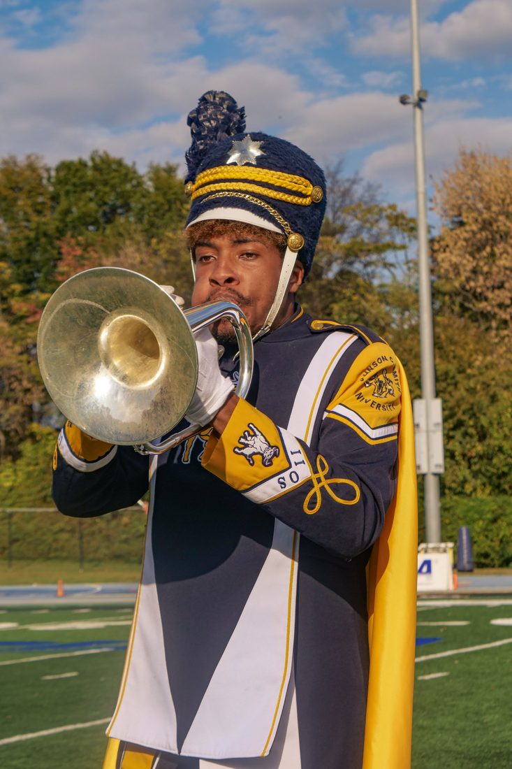 A JCSU drum major in dress whites performing
