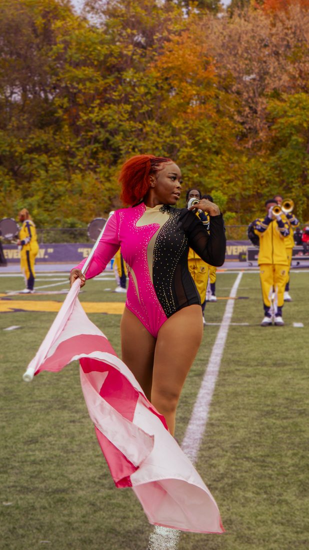 An auxiliary performer with flag