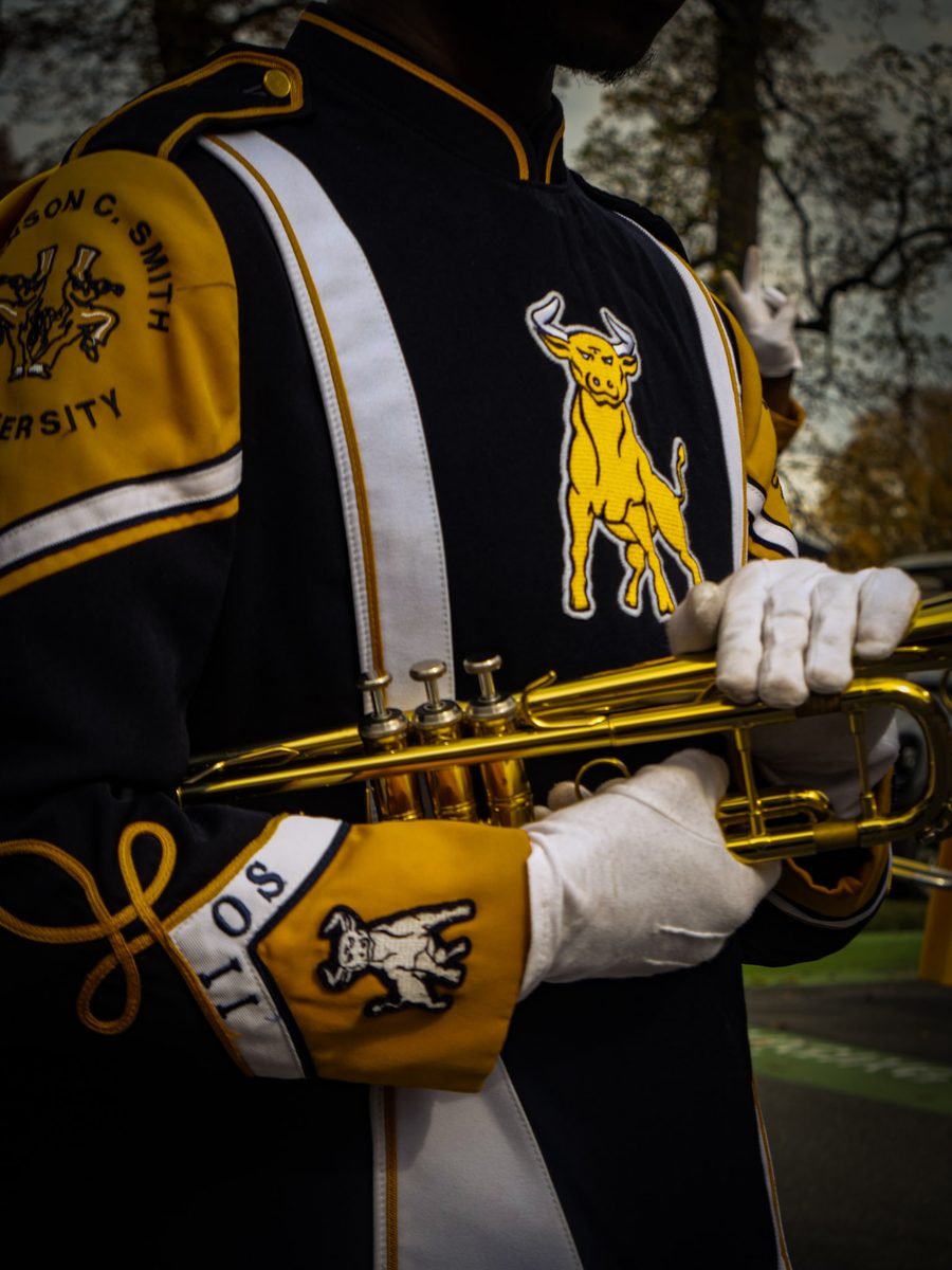 White gloves and the Golden Bull crest on a dress uniform