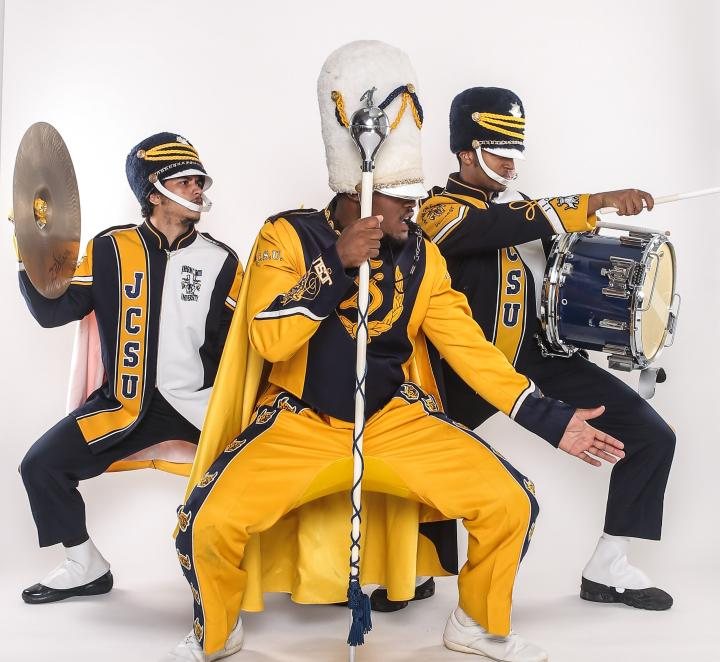 Drum major, cymbal player and snare drummer in full JCSU dress uniform