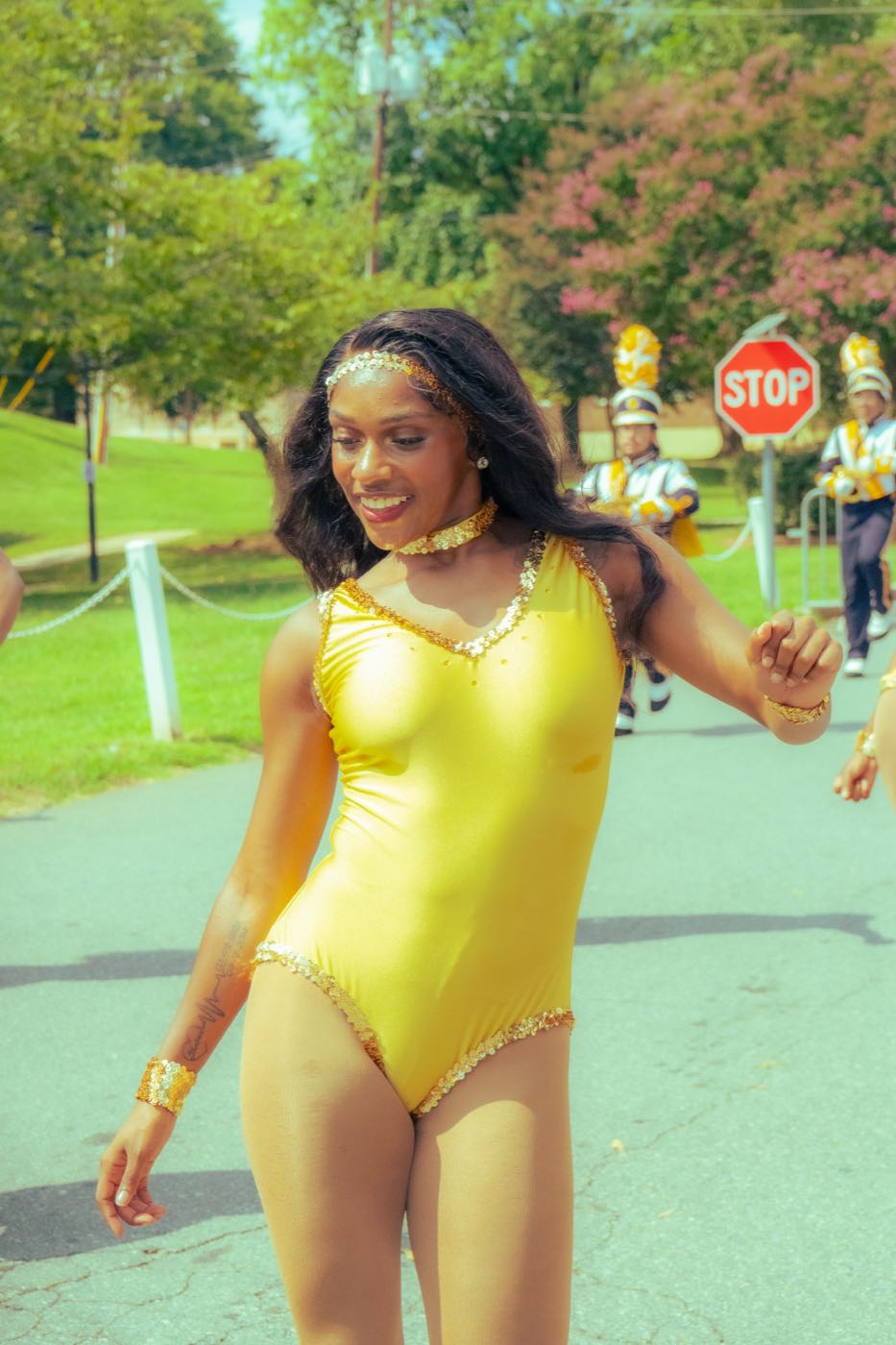 A Blue Satin dancer smiling during the parade