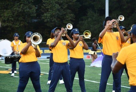 The IIOS trumpet line performing on the field