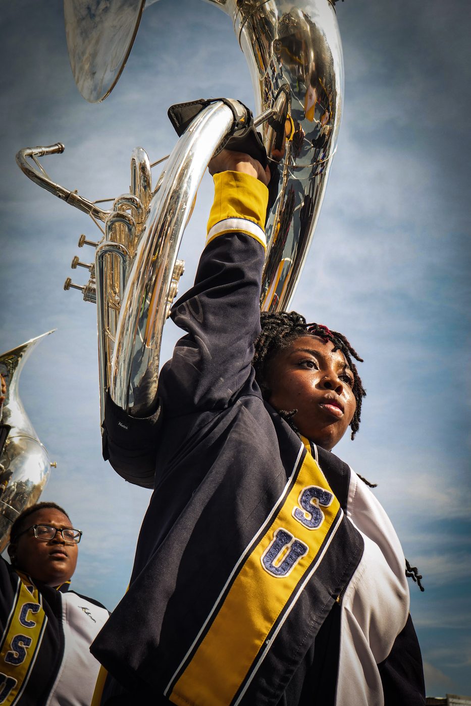A sousaphone raised against an open sky